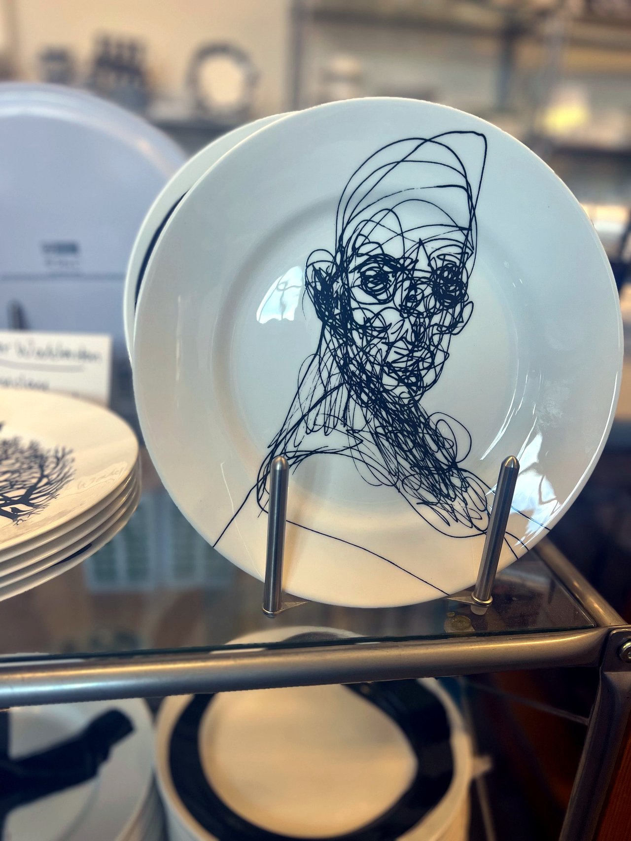 White porcelain plate with a graphic face drawn in black line