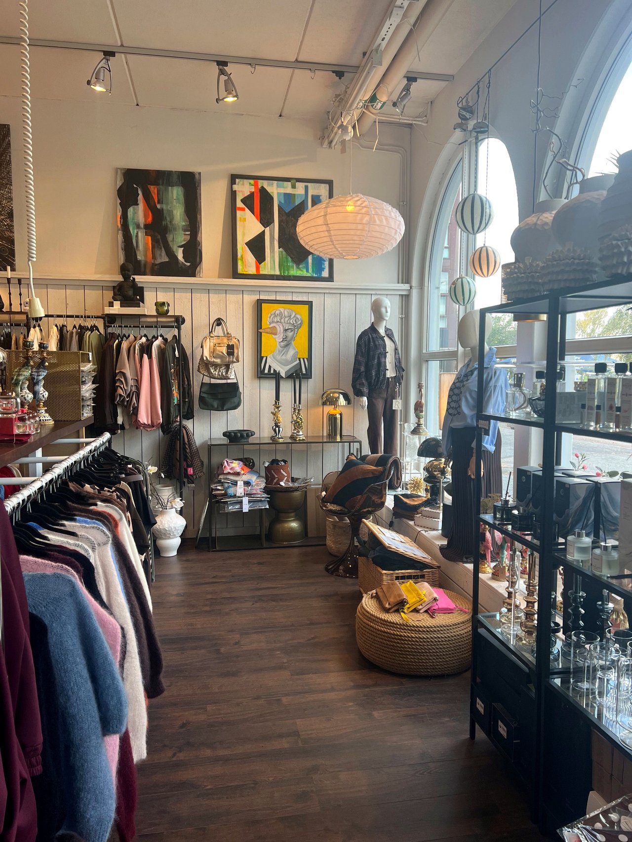 Interior of Gustavsberg Design House with art, clothing, lamps and display cabinets