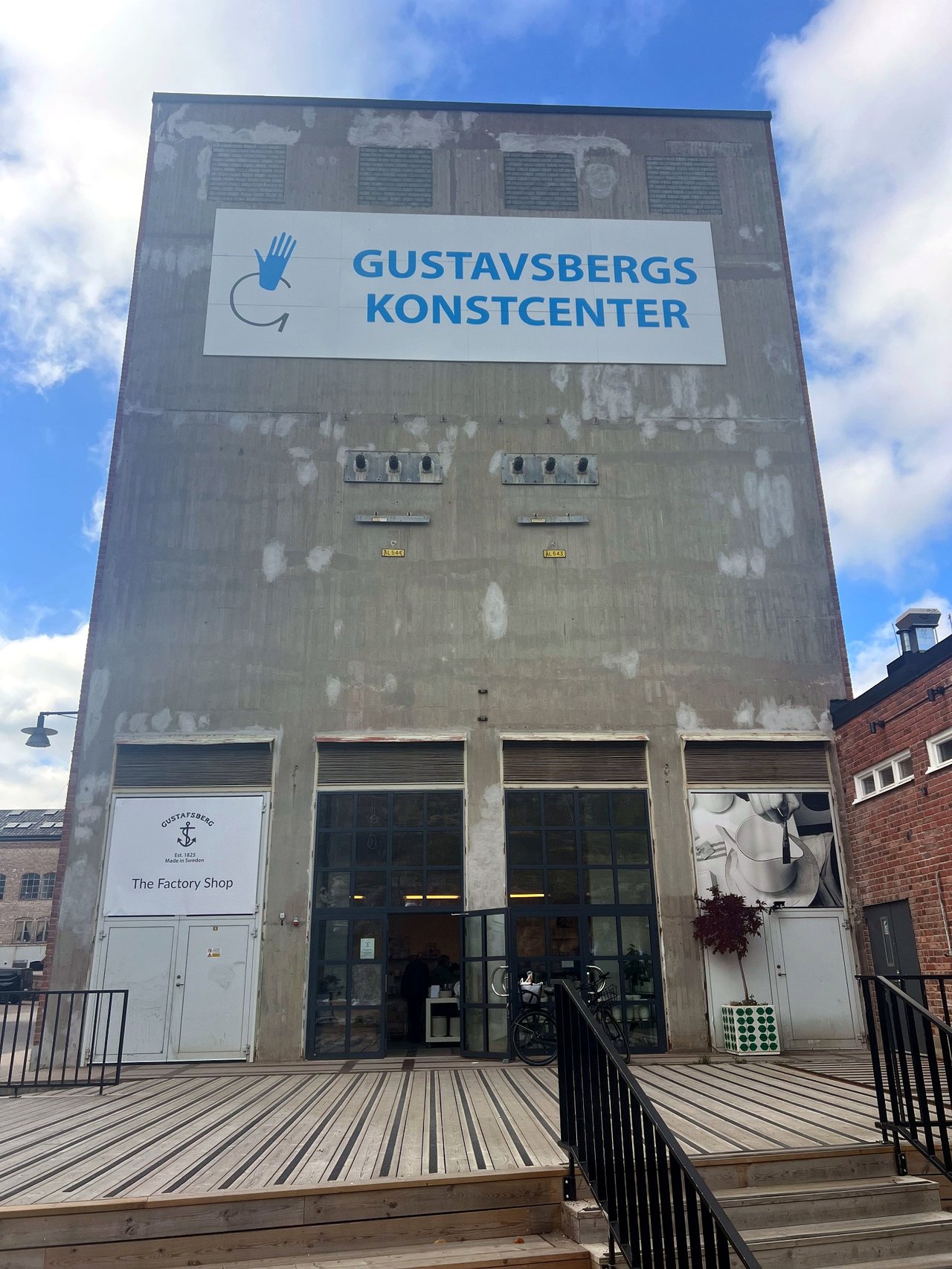 Gustavsbergs Konstcenter, a tall concrete factory building with the entrance to The Factory Shop